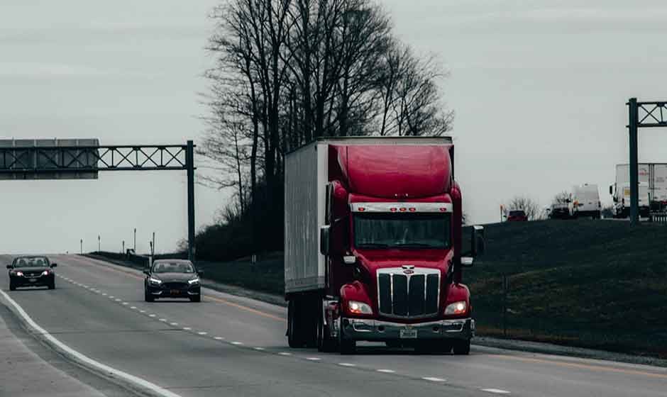 Red Semi Truck Pulling Dry Van Trailer